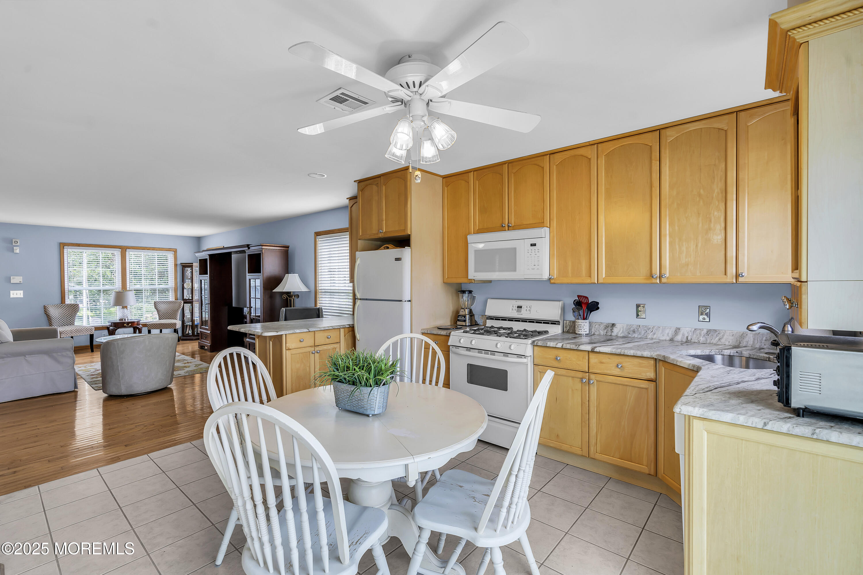 143 Lake Avenue Manasquan, NJ 08736 - Photo 6 of 18 a kitchen with a table chairs and a refrigerator