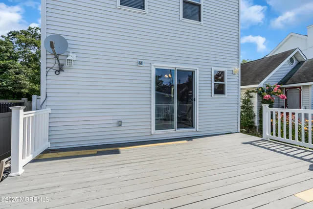 a view of a brick house with wooden floor and fence