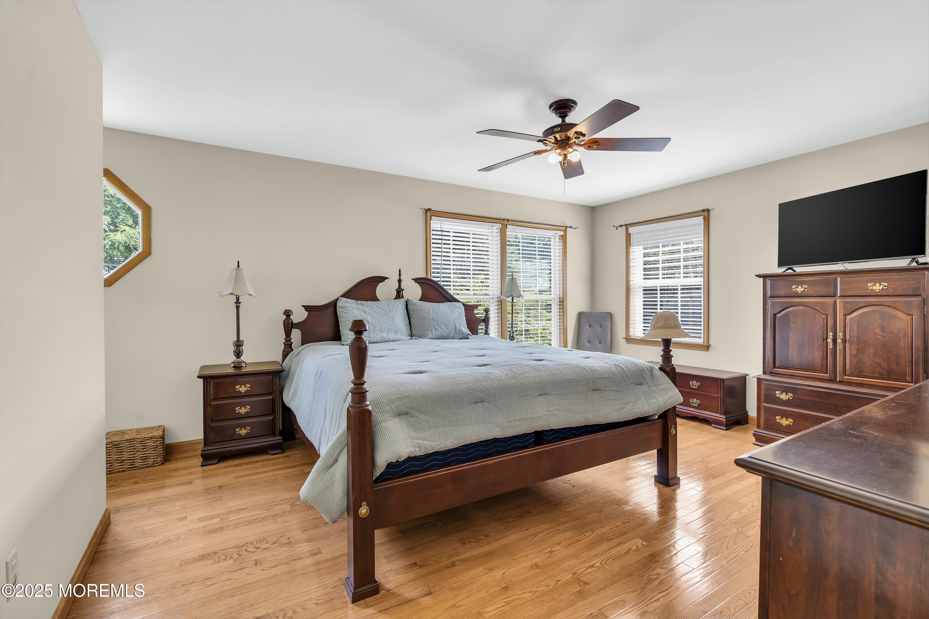 143 Lake Avenue Manasquan, NJ 08736 - Photo 10 of 18 a bedroom with a bed and a flat screen tv