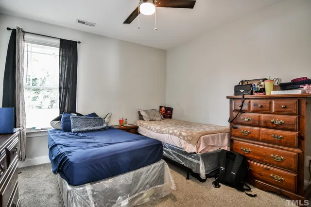 a bedroom with bed and windows