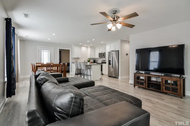 a kitchen with white cabinets and refrigerator