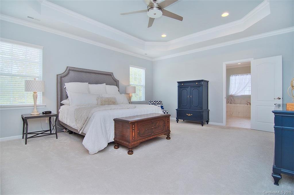 565 Brookhaven Drive Fort Mill, SC 29708 - Photo 14 of 24 a spacious bedroom with a bed and a chandelier
