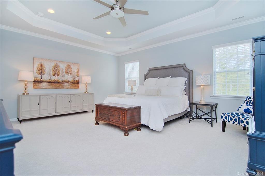 565 Brookhaven Drive Fort Mill, SC 29708 - Photo 15 of 24 a spacious bedroom with a bed and a chandelier