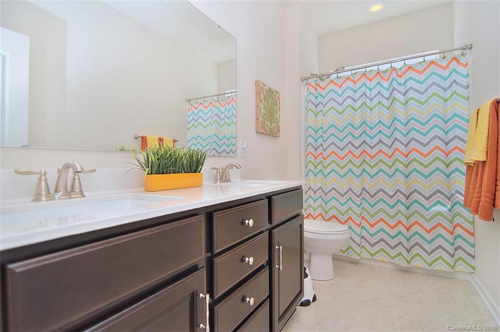 565 Brookhaven Drive Fort Mill, SC 29708 - Photo 20 of 24 a bathroom with a sink a vanity and a shower curtain
