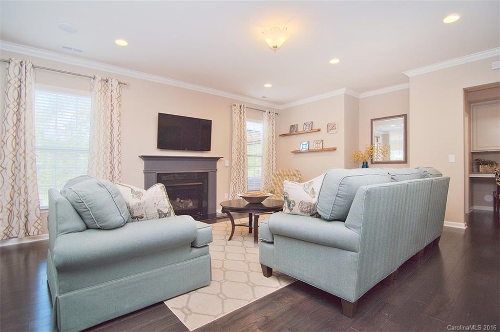 565 Brookhaven Drive Fort Mill, SC 29708 - Photo 8 of 24 a living room with furniture a fireplace and a flat screen tv