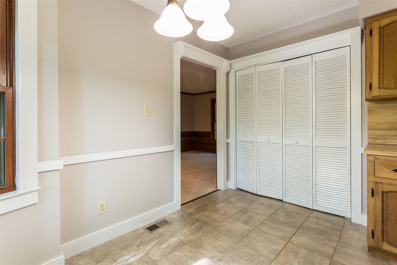 8816 Woodstone Drive Raleigh, NC 27615 - Photo 12 of 30 Laundry closet is conveniently located in the kitchen across from the breakfast nook. Laundry