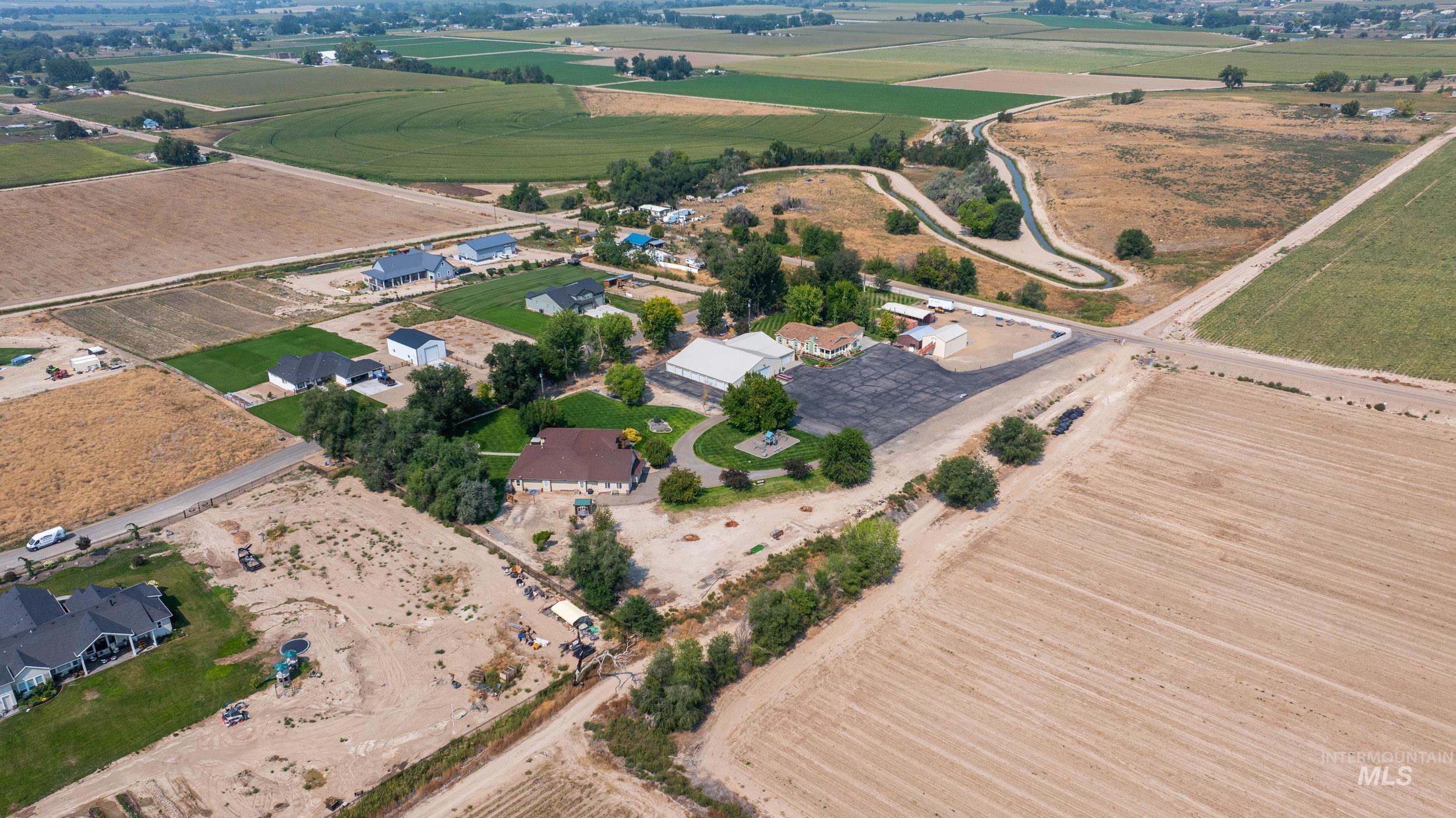 28279 Pearl Road Parma, ID 83660 - Photo 34 of 48 Aerial view of property and surrounding area featuring rural landscape and rows of crops