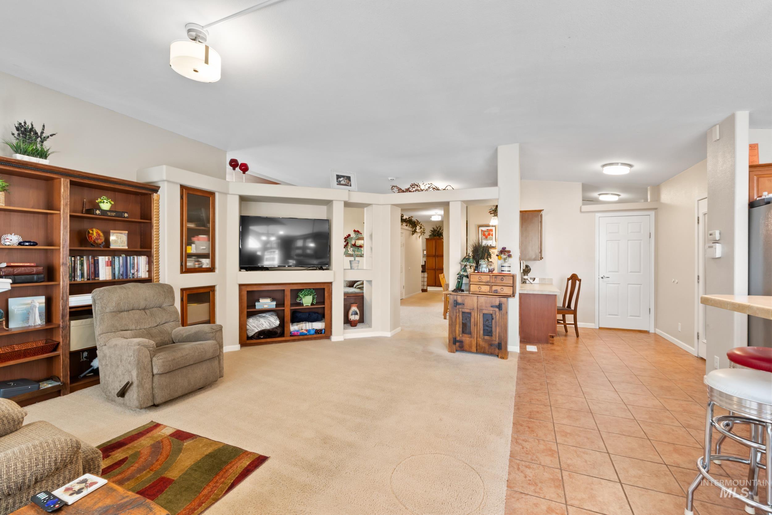 28279 Pearl Road Parma, ID 83660 - Photo 45 of 48 Living room with light tile patterned floors and light colored carpet