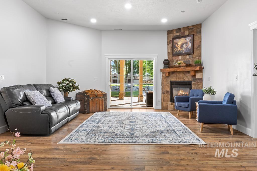 28279 Pearl Road Parma, ID 83660 - Photo 5 of 48 Living room with wood finished floors, a fireplace, and recessed lighting