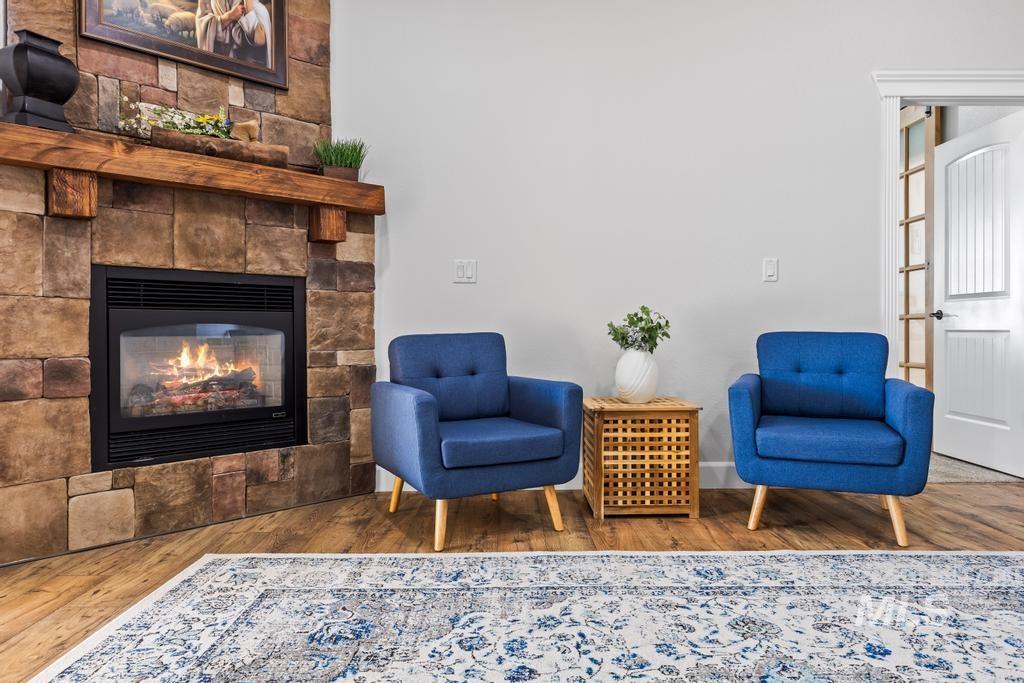 28279 Pearl Road Parma, ID 83660 - Photo 6 of 48 Living area with a glass covered fireplace and wood finished floors