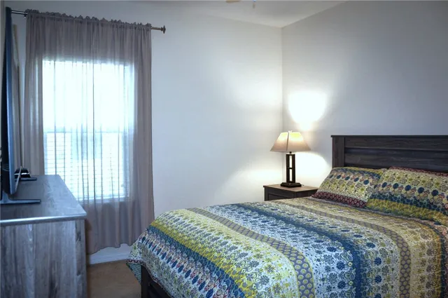 a bedroom with a bed and a lamp