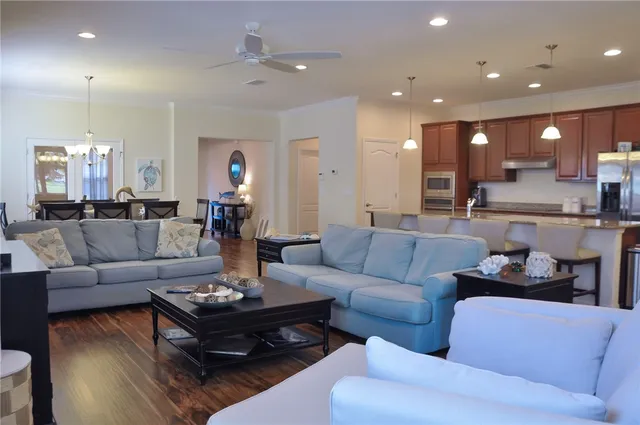 a living room with furniture and a chandelier