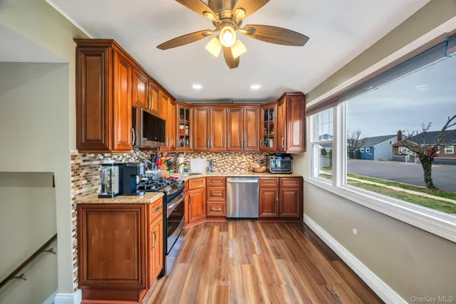 a kitchen with stove a sink dishwasher and wooden cabinets