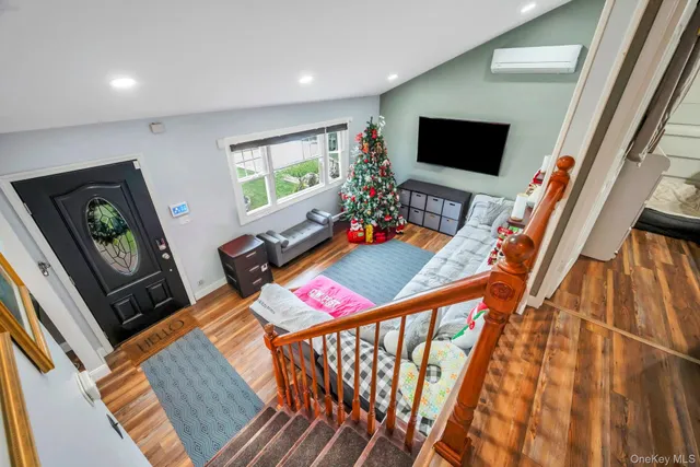 a bedroom with furniture and a flat screen tv