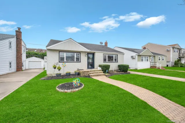 a front view of a house with a yard table and chairs
