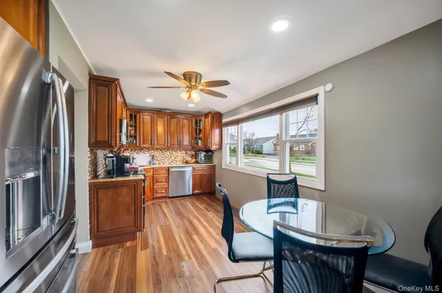 a view of a dining room with furniture a kitchen and chandelier