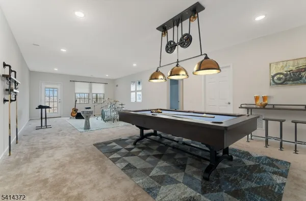 a living room with furniture a rug and gym equipment