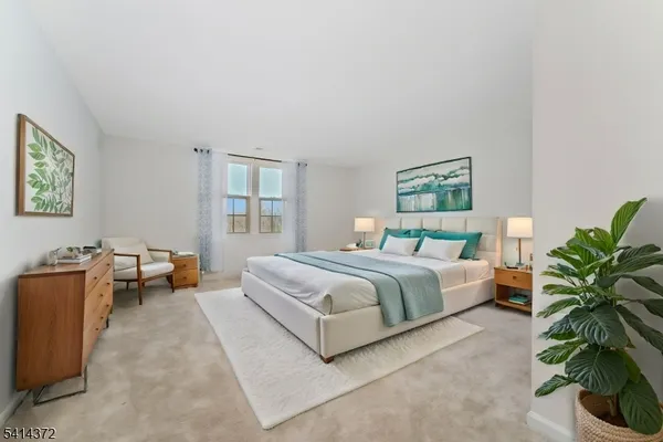 a spacious bedroom with a bed and a couch