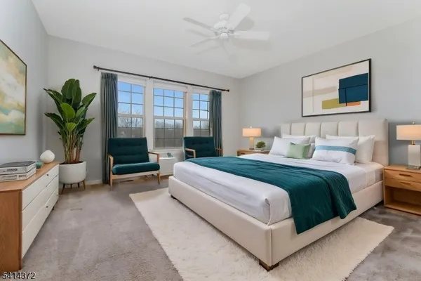 a spacious bedroom with a large bed and a potted plant