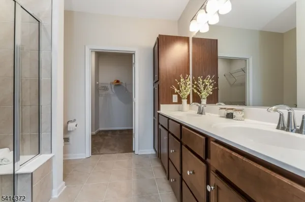 a bathroom with a double vanity sink and a mirror