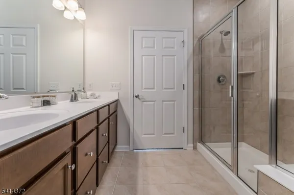 a bathroom with a double vanity sink and a mirror
