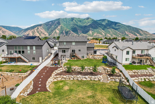 203 North 1900th Street West Mapleton, UT 84664 - Photo 41 of 48 Expansive tiered backyard featuring a manicured lawn, established rock landscaping, and mature trees