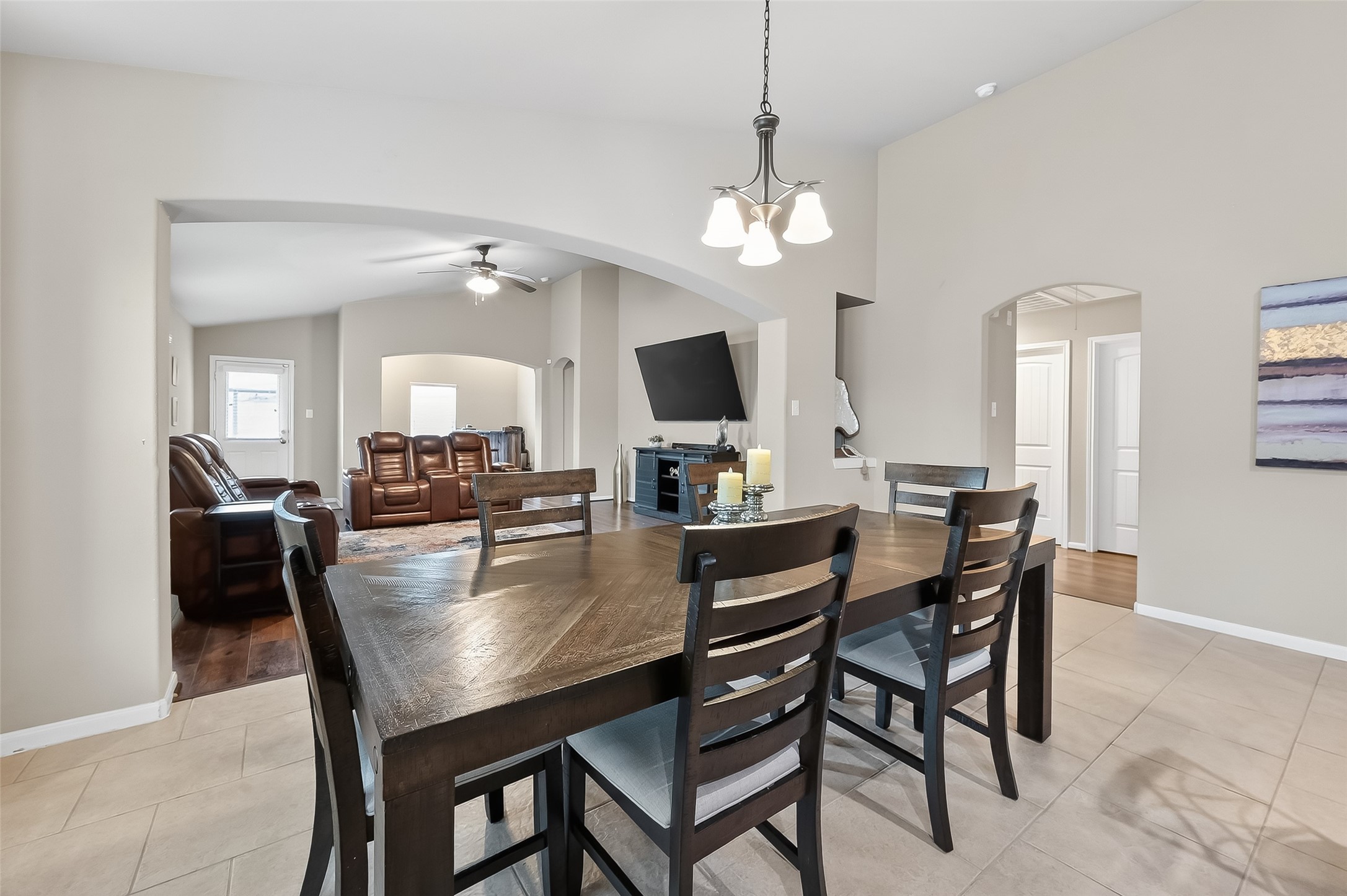5919 Micah Lane Rosenberg, TX 77471 - Photo 12 of 32 The dining area opens comfortably into the living space, offering a relaxed and airy setting. The wide archway and natural light from the windows make the space feel open and inviting, with a layout that’s both practical and easy to enjoy