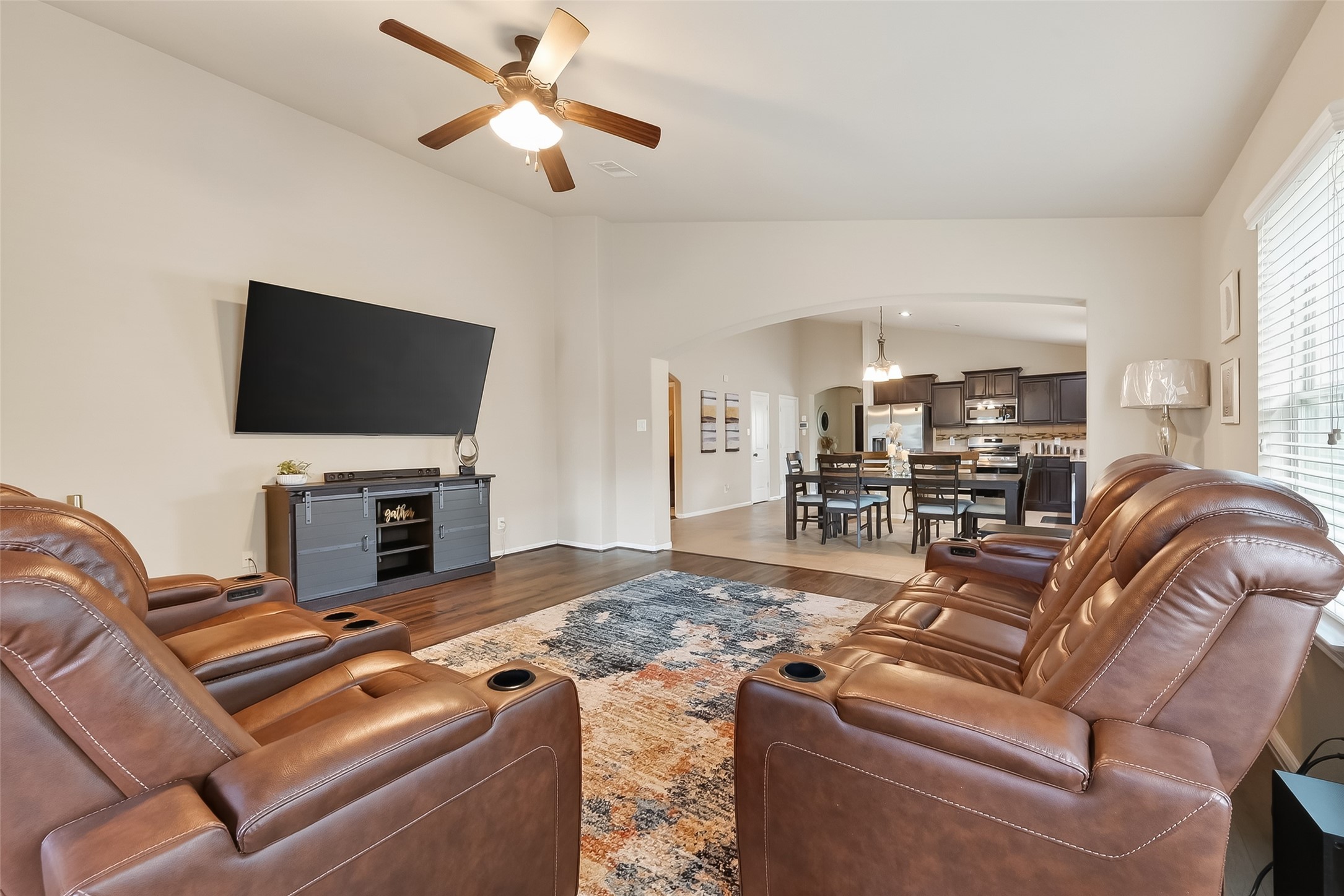 5919 Micah Lane Rosenberg, TX 77471 - Photo 17 of 32 Living room with an open connection to the kitchen and dining area, complemented by high ceilings and natural light from nearby windows