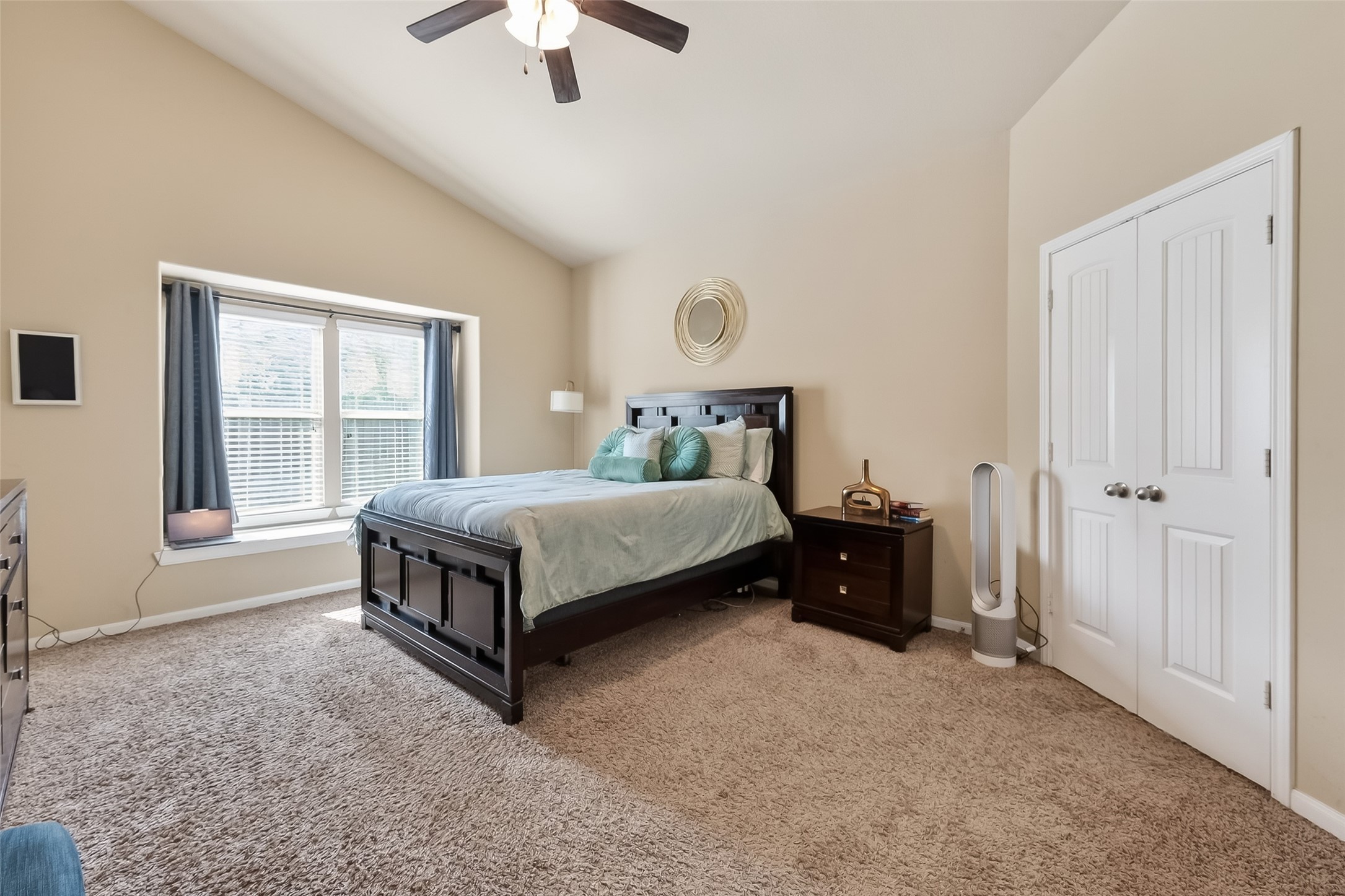 5919 Micah Lane Rosenberg, TX 77471 - Photo 22 of 32 Spacious primary bedroom featuring high ceilings and a large window that fills the room with natural light, creating an open and calming atmosphere
