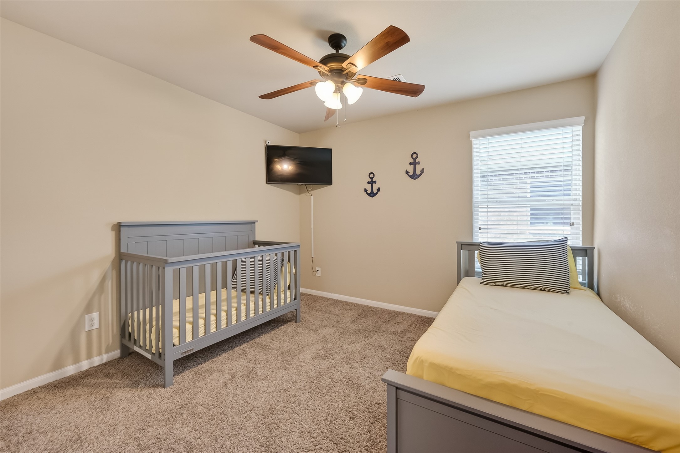 5919 Micah Lane Rosenberg, TX 77471 - Photo 29 of 32 Bright and airy bedroom with plush carpeting, featuring a ceiling fan for added comfort