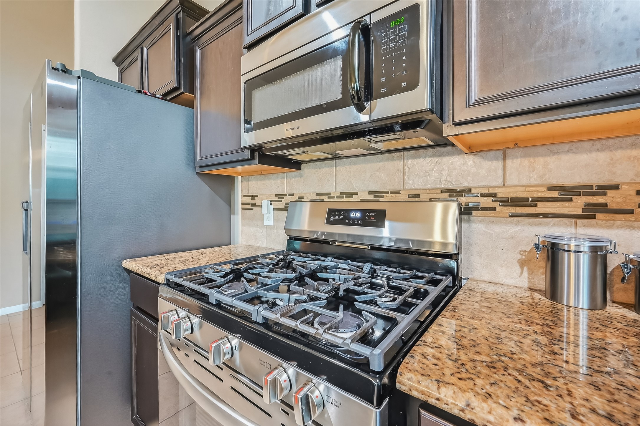 5919 Micah Lane Rosenberg, TX 77471 - Photo 10 of 32 Well-designed kitchen with stainless steel appliances and tiled backsplash