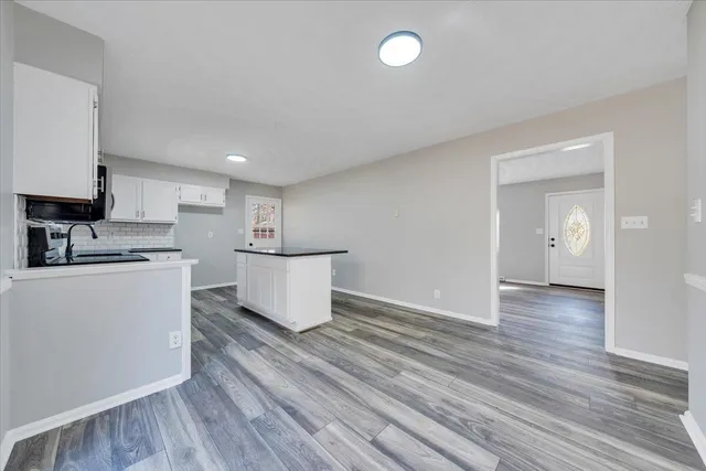 a view of kitchen with cabinets and wooden floor