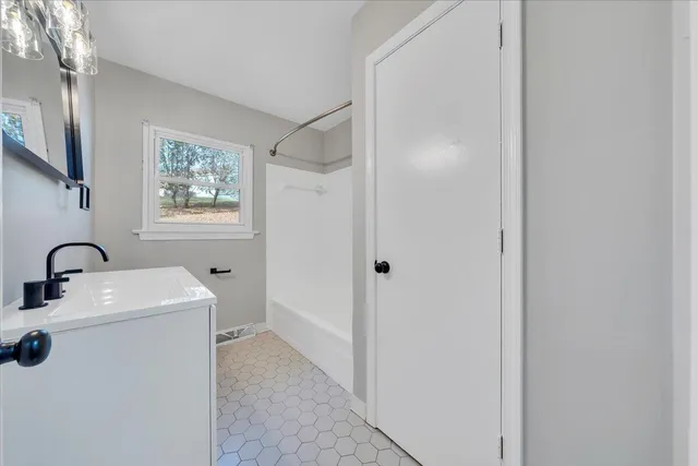 a room with a sink a washer and dryer