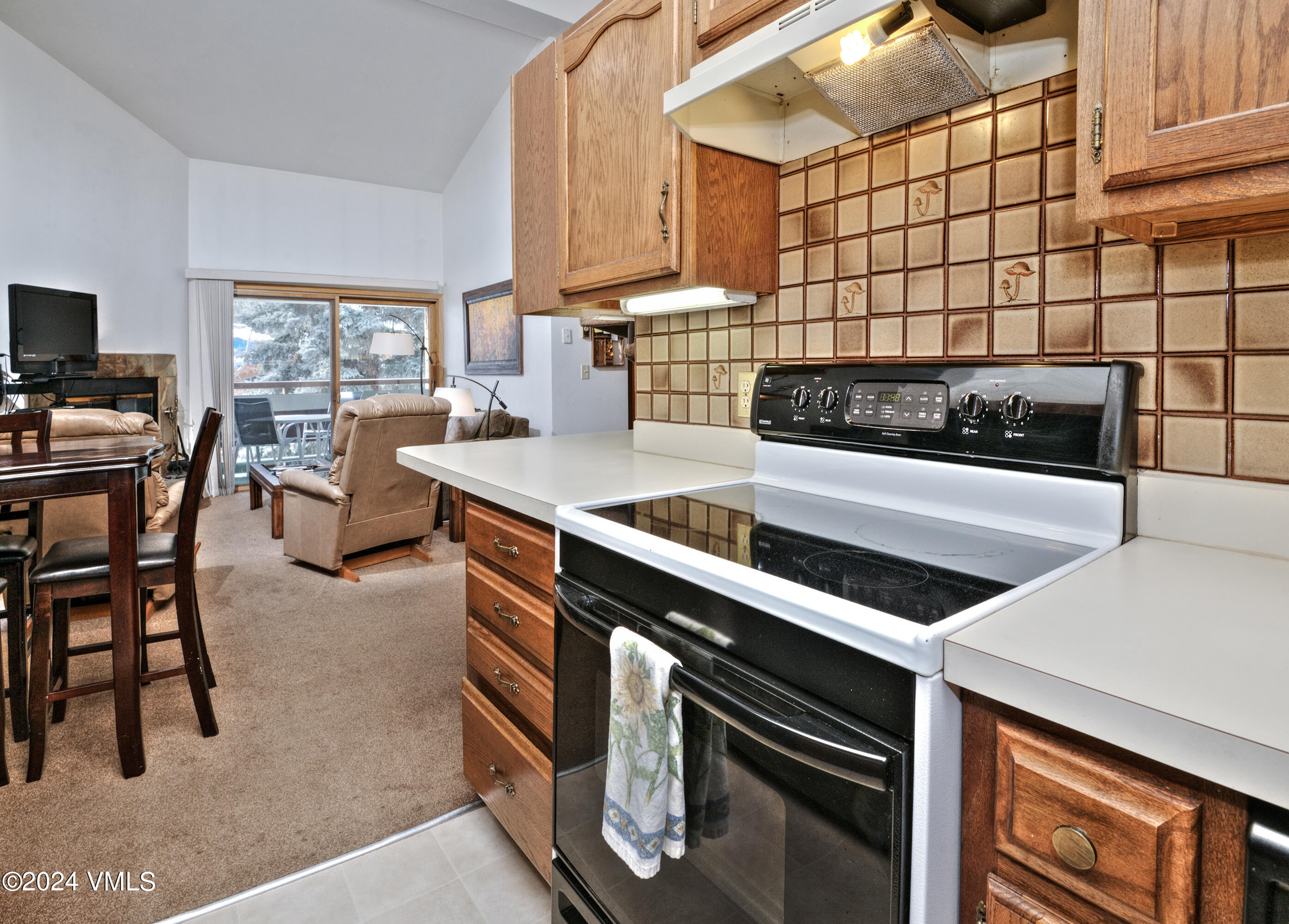 1030 Lions Ridge Loop, Unit 301 Vail, CO 81657 - Photo 14 of 28 a kitchen with stainless steel appliances kitchen island granite countertop a stove and a sink