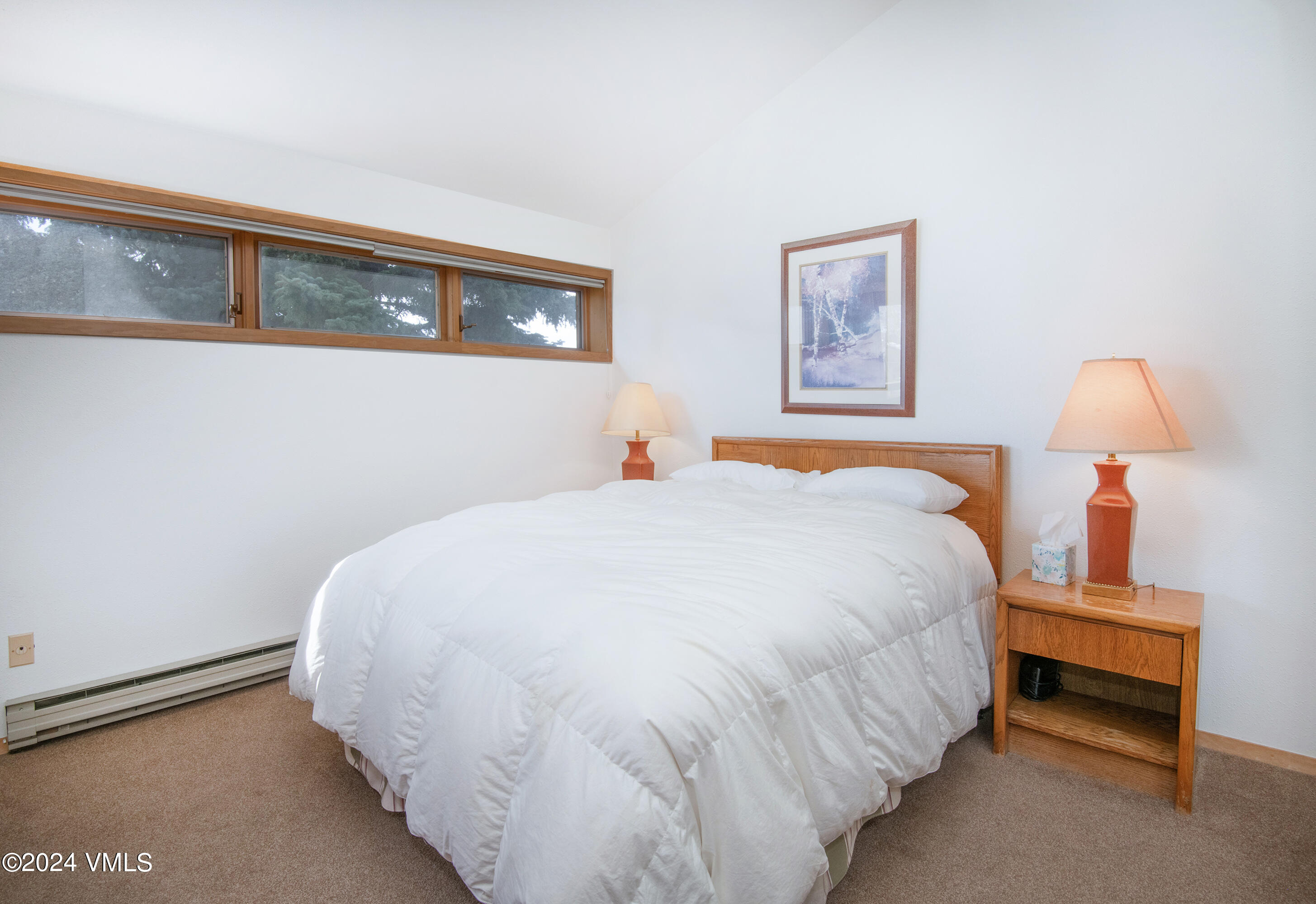 1030 Lions Ridge Loop, Unit 301 Vail, CO 81657 - Photo 16 of 28 a bed sitting in a bedroom and lamp next to a window