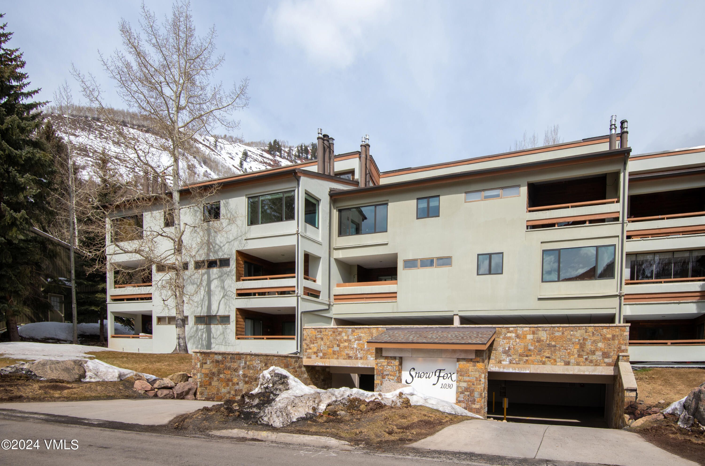 1030 Lions Ridge Loop, Unit 301 Vail, CO 81657 - Photo 2 of 28 a front view of a building with streets and trees