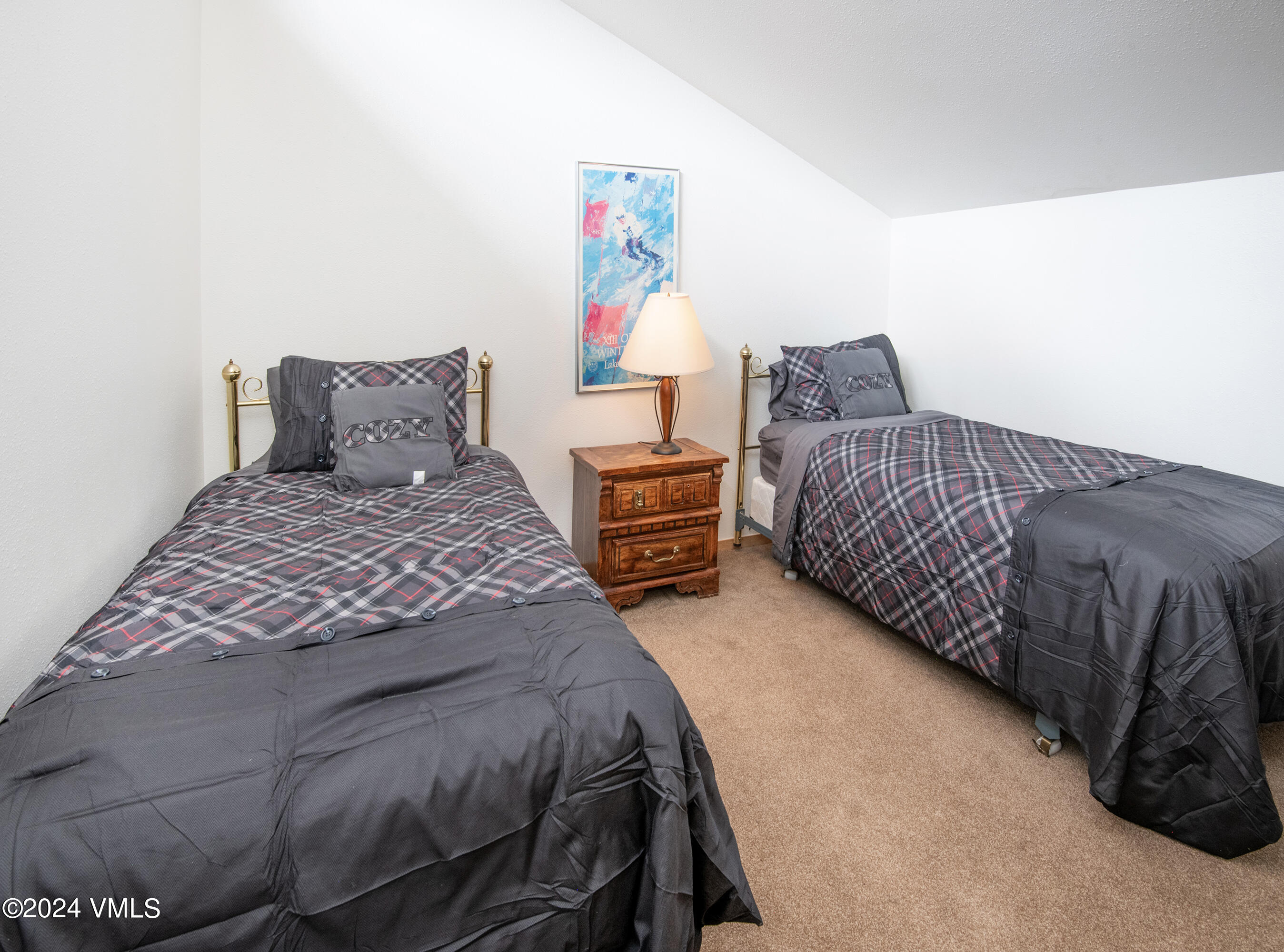 1030 Lions Ridge Loop, Unit 301 Vail, CO 81657 - Photo 24 of 28 a bedroom with a bed and cabinets