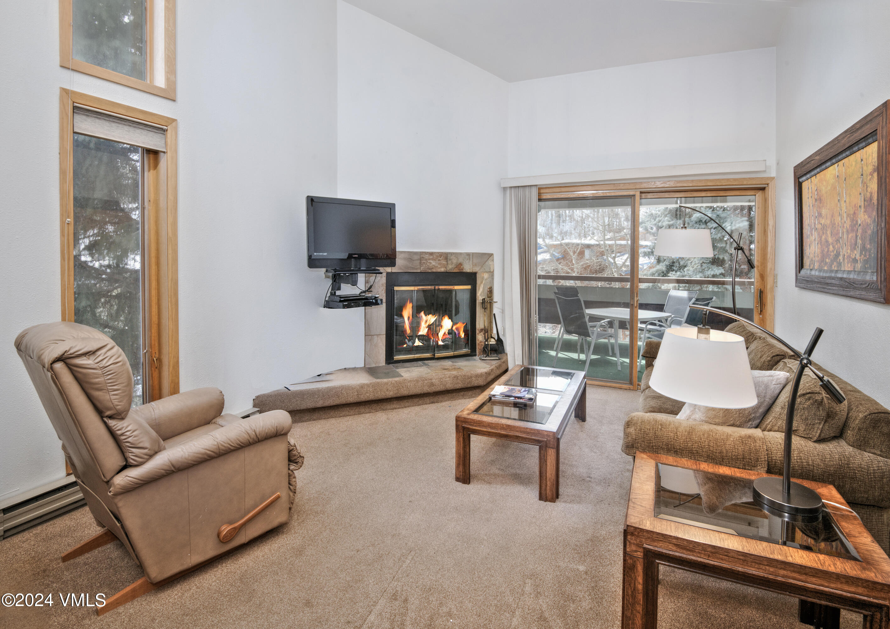 1030 Lions Ridge Loop, Unit 301 Vail, CO 81657 - Photo 5 of 28 a living room with furniture fireplace and a large window