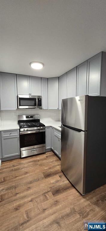 141 Grant Avenue, Unit 3 East Newark, NJ 07029 - Photo 5 of 13 a kitchen with a refrigerator and a stove top oven
