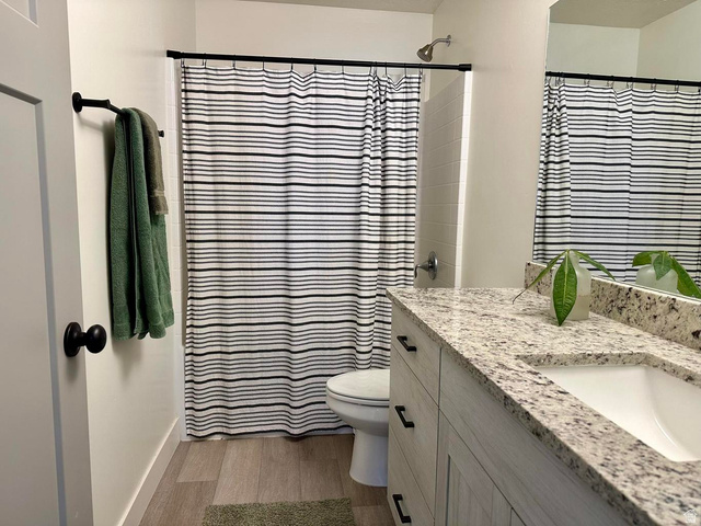 4349 Half Mile Road East Enoch, UT 84721 - Photo 31 of 36 Full bath with a shower with curtain, vanity, and light wood-style floors