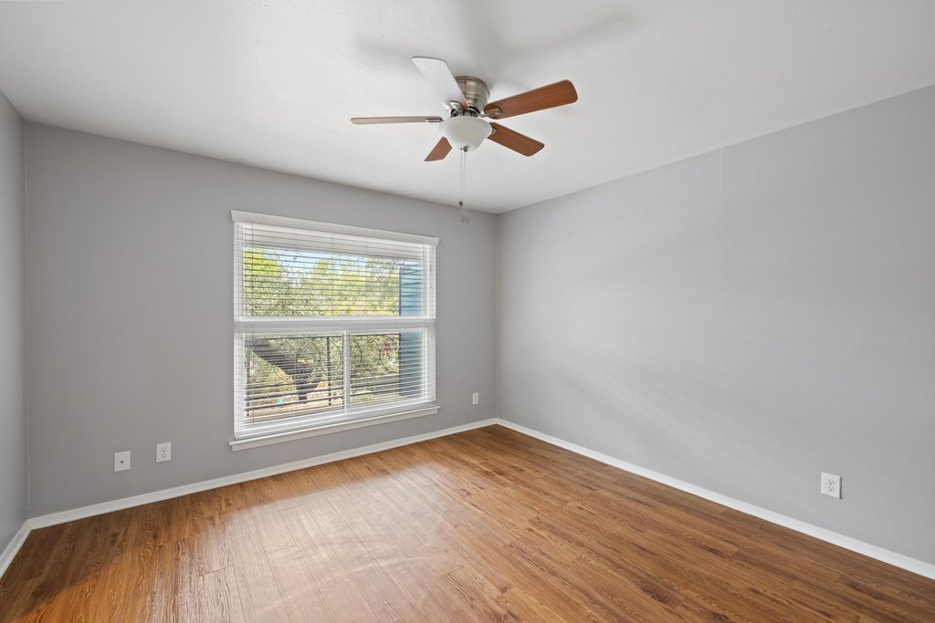 1210 Windsor Road, Unit 209 Austin, TX 78703 - Photo 13 of 38 The primary bedroom offers large windows with wonderful natural light.