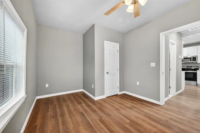 wooden floor in an empty room with a window