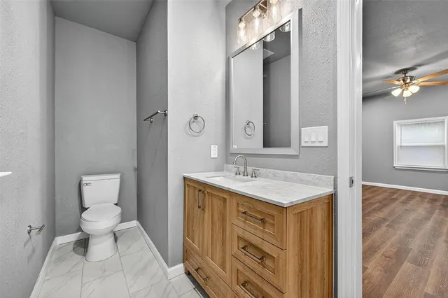 a bathroom with a sink toilet and mirror