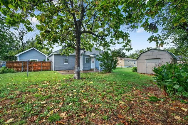 a front view of house with a garden