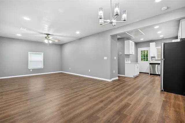 a view of a livingroom with a furniture wooden floor and chandelier