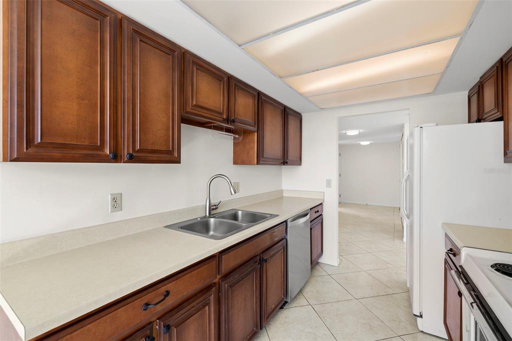 9425 Blind Pass Road, Unit 1008 St. Pete Beach, FL 33706 - Photo 15 of 65 a kitchen with a sink cabinets and appliances