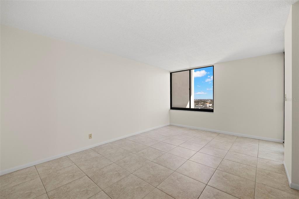 9425 Blind Pass Road, Unit 1008 St. Pete Beach, FL 33706 - Photo 19 of 65 an empty room with windows