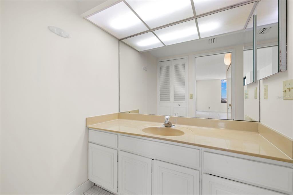9425 Blind Pass Road, Unit 1008 St. Pete Beach, FL 33706 - Photo 23 of 65 a bathroom with a sink and a mirror