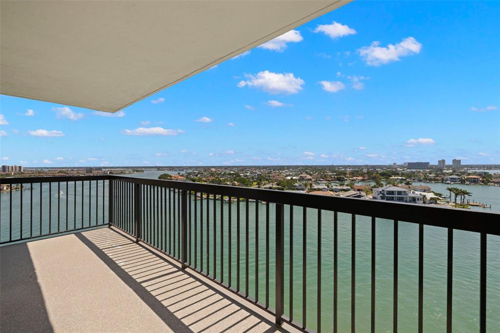 9425 Blind Pass Road, Unit 1008 St. Pete Beach, FL 33706 - Photo 31 of 65 a view of a balcony with wooden floor