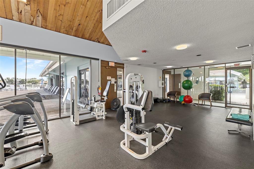 9425 Blind Pass Road, Unit 1008 St. Pete Beach, FL 33706 - Photo 38 of 65 a view of a room with gym equipment